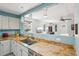 Updated kitchen featuring granite countertops with pendant lights looking into an adjacent living space at 742 Mockingbird Ln, Brighton, CO 80601