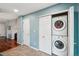 Laundry area with stackable washer and dryer tucked away for convenience at 742 Mockingbird Ln, Brighton, CO 80601