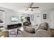 Cozy living room with hardwood floors, a ceiling fan, and lots of natural light at 742 Mockingbird Ln, Brighton, CO 80601