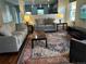 Bright living room with hardwood floors, area rug, large couches and a large television at 742 Mockingbird Ln, Brighton, CO 80601