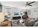 Bright living room features plush seating, large windows, ceiling fan and modern decor at 742 Mockingbird Ln, Brighton, CO 80601