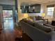 Open concept living room with hardwood floors, backyard views, and comfortable seating at 742 Mockingbird Ln, Brighton, CO 80601