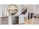Contemporary bar area with stylish mirror, sleek cabinets, wine cooler, and modern tile backsplash at 1768 Peak Loop, Broomfield, CO 80023
