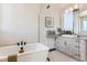 Bright bathroom featuring a freestanding tub and modern vanity at 1768 Peak Loop, Broomfield, CO 80023
