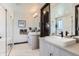 Modern bathroom with dual sinks, sleek cabinets, and a glass-enclosed shower at 1768 Peak Loop, Broomfield, CO 80023