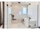 Bathroom featuring a luxurious tub with a glass-enclosed shower and bench at 1768 Peak Loop, Broomfield, CO 80023
