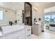 Bathroom showcasing dual sinks, a modern vanity, and glass-enclosed shower at 1768 Peak Loop, Broomfield, CO 80023