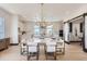 Dining area with modern chandelier, open to a kitchen with a tile backsplash, and sliding barn doors at 1768 Peak Loop, Broomfield, CO 80023