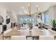 Dining area offering a view of the living room fireplace, a modern kitchen, and a sliding glass door to a balcony at 1768 Peak Loop, Broomfield, CO 80023