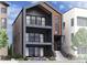 Contemporary three-story home with balconies, modern design, and landscaped front yard at 1768 Peak Loop, Broomfield, CO 80023