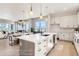 Gourmet kitchen featuring large island, stainless steel appliances, and open layout connecting dining and living spaces at 1768 Peak Loop, Broomfield, CO 80023