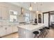 Bright kitchen with modern cabinetry, stainless steel appliances, large island, and designer tile backsplash at 1768 Peak Loop, Broomfield, CO 80023