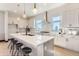 Modern kitchen featuring a spacious island, stylish pendant lights, and stainless steel appliances at 1768 Peak Loop, Broomfield, CO 80023