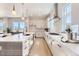 Contemporary kitchen with sleek cabinetry, center island, stainless steel appliances, and hardwood floors at 1768 Peak Loop, Broomfield, CO 80023