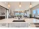 Spacious kitchen island with sink and modern fixtures overlooking the dining and living areas at 1768 Peak Loop, Broomfield, CO 80023
