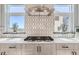 Stylish kitchen features modern appliances, elegant backsplash, and ample counter space with bright windows at 1768 Peak Loop, Broomfield, CO 80023
