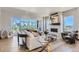 Light-filled living room boasts a contemporary fireplace, chic furnishings, and an inviting view from a large balcony at 1768 Peak Loop, Broomfield, CO 80023