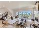 Bright living room with a modern fireplace, stylish decor, and large windows offering a beautiful view at 1768 Peak Loop, Broomfield, CO 80023