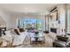 Spacious living room with a modern fireplace, comfortable seating, and sliding glass doors to a relaxing outdoor balcony at 1768 Peak Loop, Broomfield, CO 80023