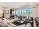 Bright living room featuring a bar area, comfortable seating, and a sliding door to the outside at 1768 Peak Loop, Broomfield, CO 80023