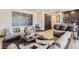 Open-concept living room with modern furnishings, stylish bar area, and elegant decor at 1768 Peak Loop, Broomfield, CO 80023