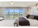 Bright main bedroom featuring floor-to-ceiling windows and sophisticated modern decor at 1768 Peak Loop, Broomfield, CO 80023