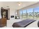 Main bedroom with a fireplace, large window, and community views at 1768 Peak Loop, Broomfield, CO 80023