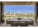 Relaxing patio area with dining table and seating, offering a beautiful view of the community at 1768 Peak Loop, Broomfield, CO 80023