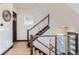 Modern staircase with wood treads, cable railings, and contemporary design elements at 1768 Peak Loop, Broomfield, CO 80023
