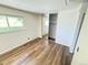 Bright bedroom with sleek mirrored closets and wood-look floors, offering a modern and spacious feel at 9255 E Lehigh # 213, Denver, CO 80237
