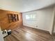 Cozy bedroom with natural light, featuring wood-look floors and a built-in bookcase adding character to the space at 9255 E Lehigh # 213, Denver, CO 80237