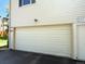 Detached white garage featuring a large garage door, siding, and a marked fire lane at 9255 E Lehigh # 213, Denver, CO 80237