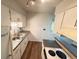 Practical kitchen with stainless steel sink, electric range, and ample storage space at 9255 E Lehigh # 213, Denver, CO 80237