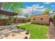 View of the backyard featuring a patio, green grass, garden beds and a detached structure at 2738 W 38Th Ave, Denver, CO 80211