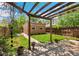 Landscaped backyard featuring a pergola, a brick building, and a stone patio at 2738 W 38Th Ave, Denver, CO 80211