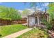 Backyard with a stone patio, pergola, grassy area, and a detached structure at 2738 W 38Th Ave, Denver, CO 80211