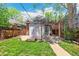 Backyard featuring a pergola, stone patio, grassy area, and a detached structure at 2738 W 38Th Ave, Denver, CO 80211