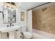 Charming bathroom with a pedestal sink, decorative mirror, and tiled shower at 2738 W 38Th Ave, Denver, CO 80211