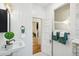 Stylish bathroom featuring beadboard paneling, modern fixtures, and a view to the hallway at 2738 W 38Th Ave, Denver, CO 80211