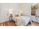 Bright bedroom featuring hardwood floors, a plush bed, and a sunlit window at 2738 W 38Th Ave, Denver, CO 80211