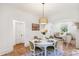 Charming dining area with hardwood floors, a stylish light fixture, and a view into the living room at 2738 W 38Th Ave, Denver, CO 80211