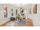 Bright dining room with hardwood floors, modern light fixture, and adjacent kitchen view at 2738 W 38Th Ave, Denver, CO 80211