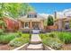 Charming brick home with well-manicured lawn, inviting front porch, and wrought iron fence at 2738 W 38Th Ave, Denver, CO 80211