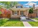 Charming brick home with inviting porch, manicured lawn, and classic architectural details at 2738 W 38Th Ave, Denver, CO 80211