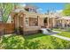 Charming brick home with inviting porch and lush green lawn, creating a welcoming curb appeal at 2738 W 38Th Ave, Denver, CO 80211