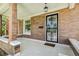 Inviting front porch featuring stylish tile flooring, decorative door, and brick pillars at 2738 W 38Th Ave, Denver, CO 80211