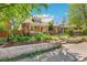 Charming brick home with landscaped front yard, featuring a well-manicured lawn, flower beds, and a welcoming entrance at 2738 W 38Th Ave, Denver, CO 80211