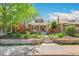 Charming brick home with landscaped front yard, featuring a well-manicured lawn, flower beds, and a welcoming entrance at 2738 W 38Th Ave, Denver, CO 80211