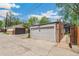 View of the detached garages with concrete driveway and backyard fence at 2738 W 38Th Ave, Denver, CO 80211