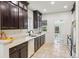 Well-lit kitchen featuring dark cabinets, stone floors, and a view to the front door at 2738 W 38Th Ave, Denver, CO 80211